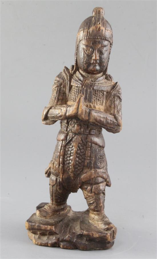 A Chinese carved wood figure of a warrior, Ming dynasty, height 31.2cm, old losses and age cracks